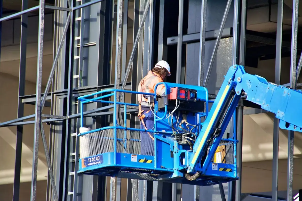 Construction worker using a lift at a building site in Sydney